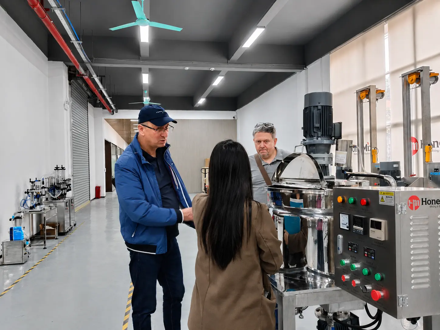 AFM-CR Machine Operation Training for Polish Customer HONEMIX engineer explaining the AFM-CR cream jar filling and capping machine to the Polish customer
