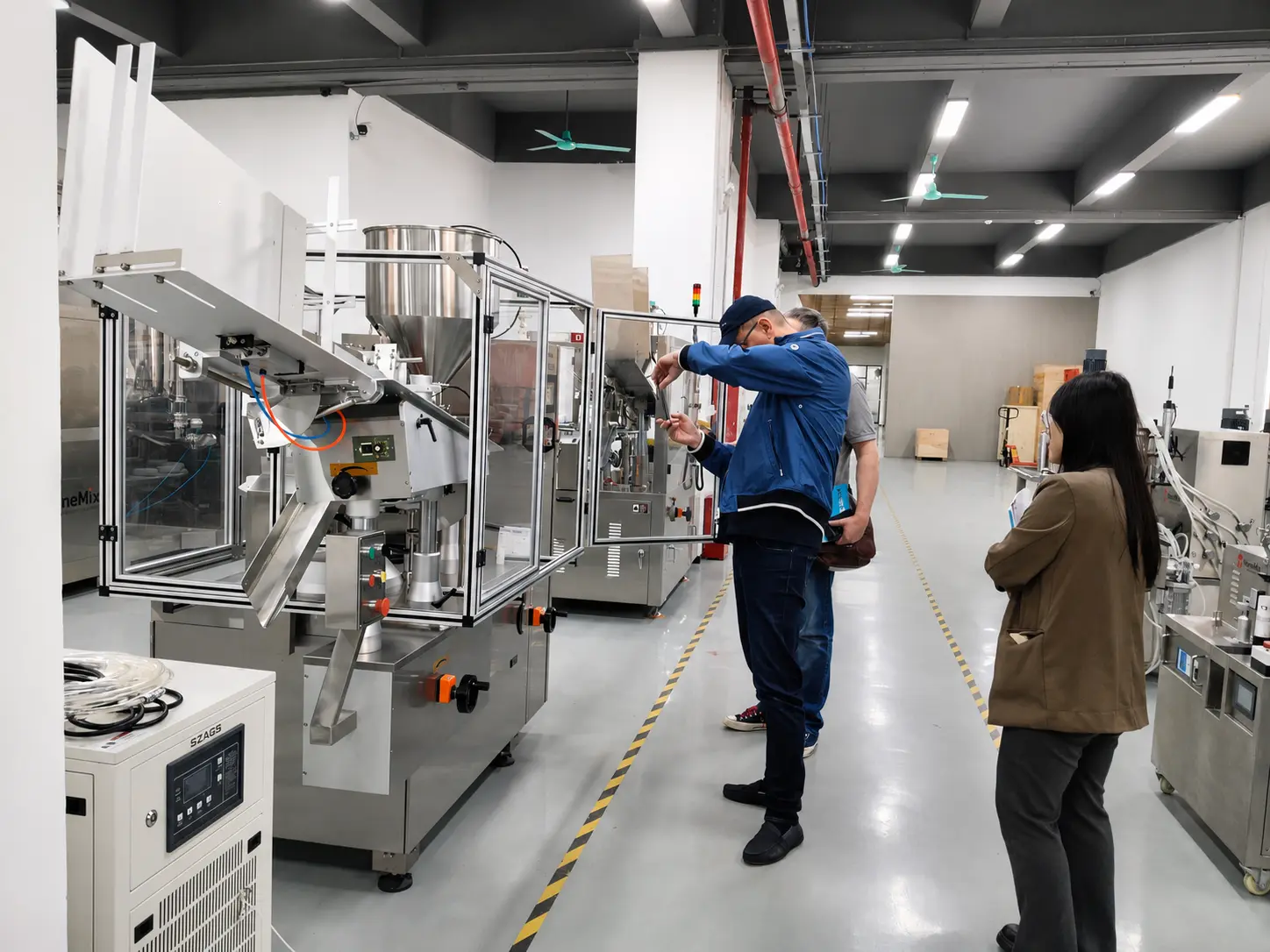 AFM-CR Factory Acceptance Test for Polish Customer Polish customer checking the AFM-CR automatic cream jar filling and capping machine during factory acceptance testing